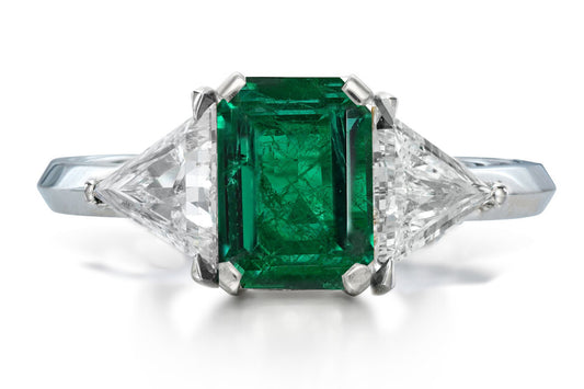 516 custom made unique emerald cut emerald center stone and trillion diamond accent three stone engagement ring