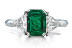 516 custom made unique emerald cut emerald center stone and trillion diamond accent three stone engagement ring