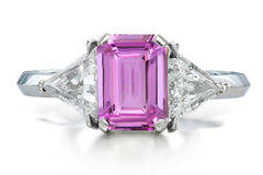 516 custom made unique emerald cut pink sapphire center stone and trillion diamond accent three stone engagement ring