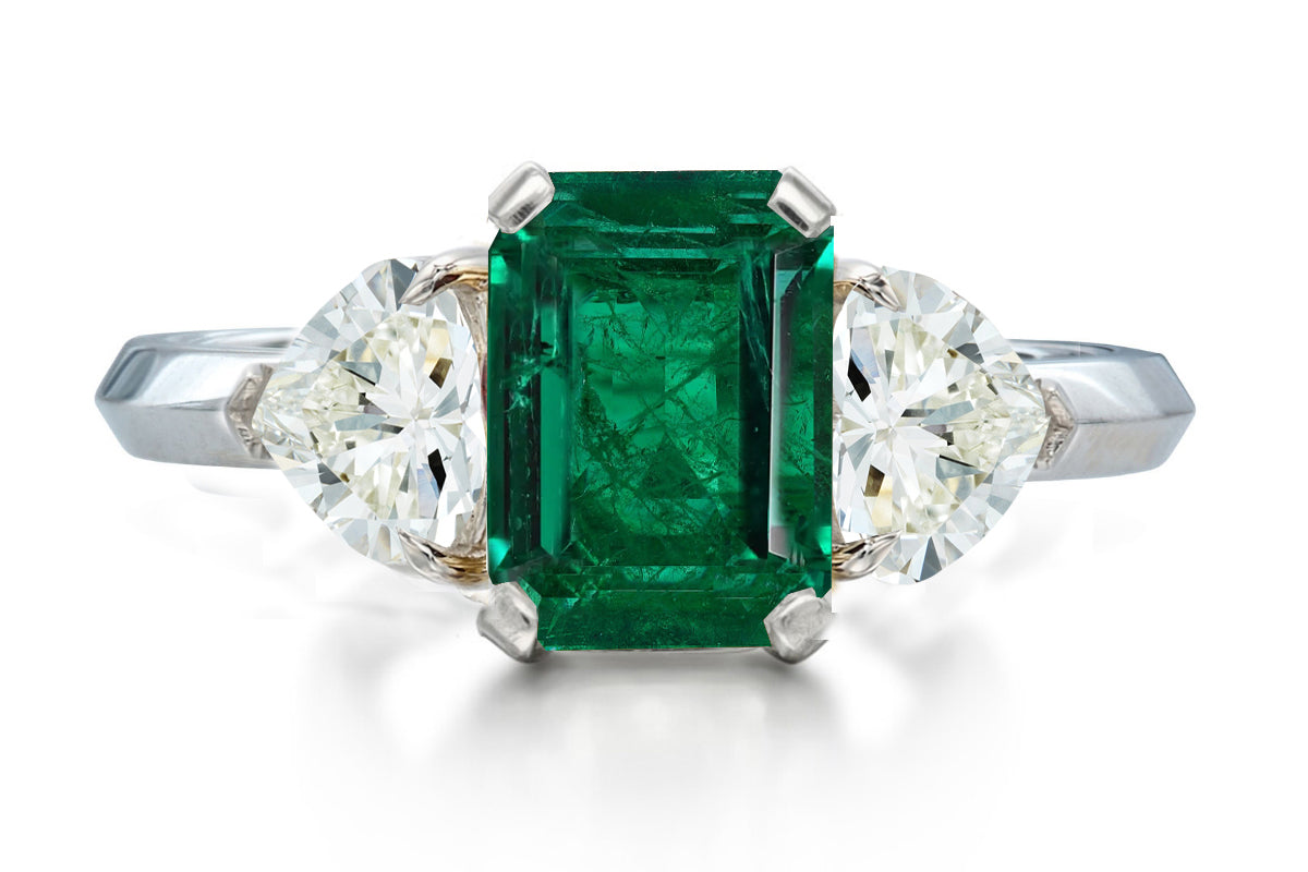 517 custom made unique emerald cut emerald center stone and heart diamond accent three stone engagement ring