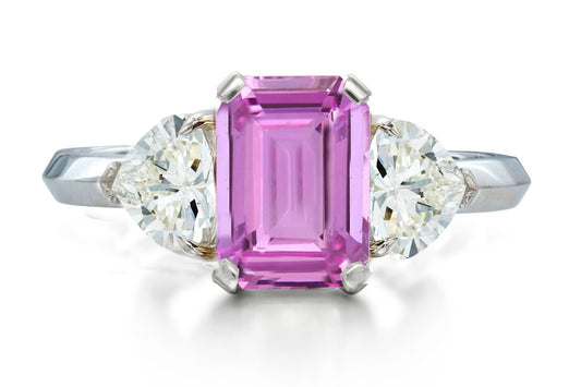 517 custom made unique emerald cut pink sapphire center stone and heart diamond accent three stone engagement ring