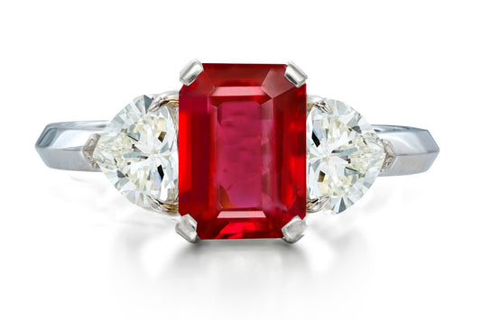 517 custom made unique emerald cut ruby center stone and heart diamond accent three stone engagement ring