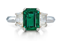 518 custom made unique emerald cut emerald center stone and trapezoid diamond accent three stone engagement ring