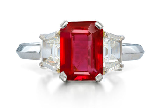 518 custom made unique emerald cut ruby center stone and trapezoid diamond accent three stone engagement ring