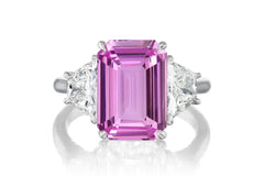 523 custom made unique emerald cut pink sapphire center stone and trapezoid diamond accent three stone engagement ring