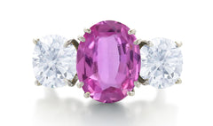 550 custom made unique oval pink sapphire center stone and round diamond accent three stone engagement ring