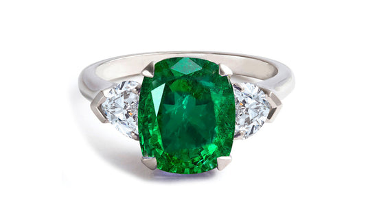 604 custom made unique cushion emerald center stone and heart diamond three stone engagement ring