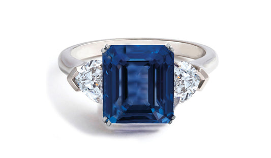 605 custom made unique emerald cut blue sapphire center stone and heart diamond three stone engagement ring