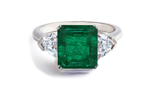 605 custom made unique emerald cut emerald center stone and heart diamond three stone engagement ring