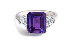 605 custom made unique emerald cut purple sapphire center stone and heart diamond three stone engagement ring