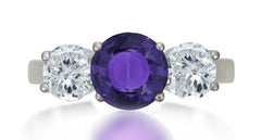 621 custom made unique round purple sapphire center stone and round diamond accent three stone engagement ring