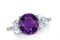 643 custom made unique round purple sapphire center stone and heart diamond accent three stone engagement ring