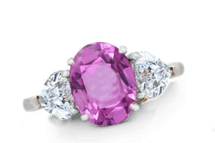 644 custom made unique oval pink sapphire center stone and heart diamond accent three stone engagement ring