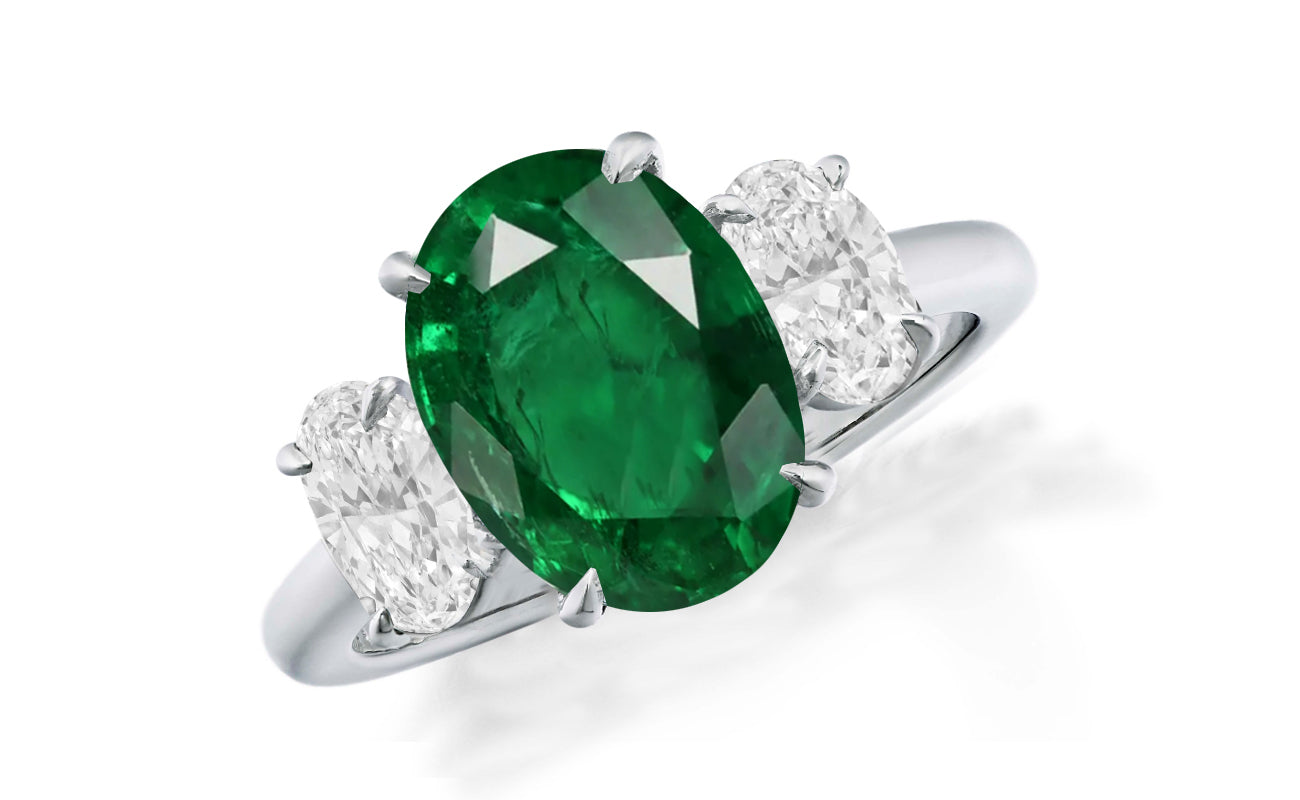 648 custom made unique oval emerald center stone and oval diamond accent three stone engagement ring