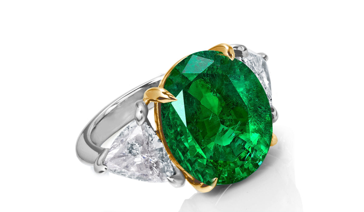 649 custom made unique oval emerald center stone and trillion diamond accent three stone engagement ring