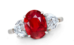 656 custom made unique oval ruby center stone and heart diamond accent three stone engagement ring