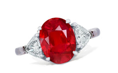 658 custom made unique oval ruby center stone and trillion diamond accent three stone engagement ring