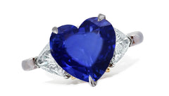 659 custom made unique heart blue sapphire center stone and trillion diamond accent three stone engagement ring