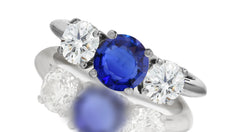 667 custom made unique round blue sapphire center stone and round diamond accent three stone engagement ring