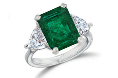 669 custom made unique emerald cut emerald center stone and heart diamond accent three stone engagement ring