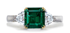 679 custom made unique asscher cut emerald center stone and heart diamond accent three stone engagement ring