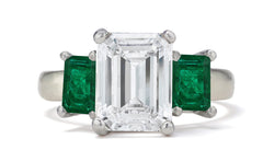 681 custom made unique emerald cut diamond center stone and emerald cut emerald accent three stone engagement ring