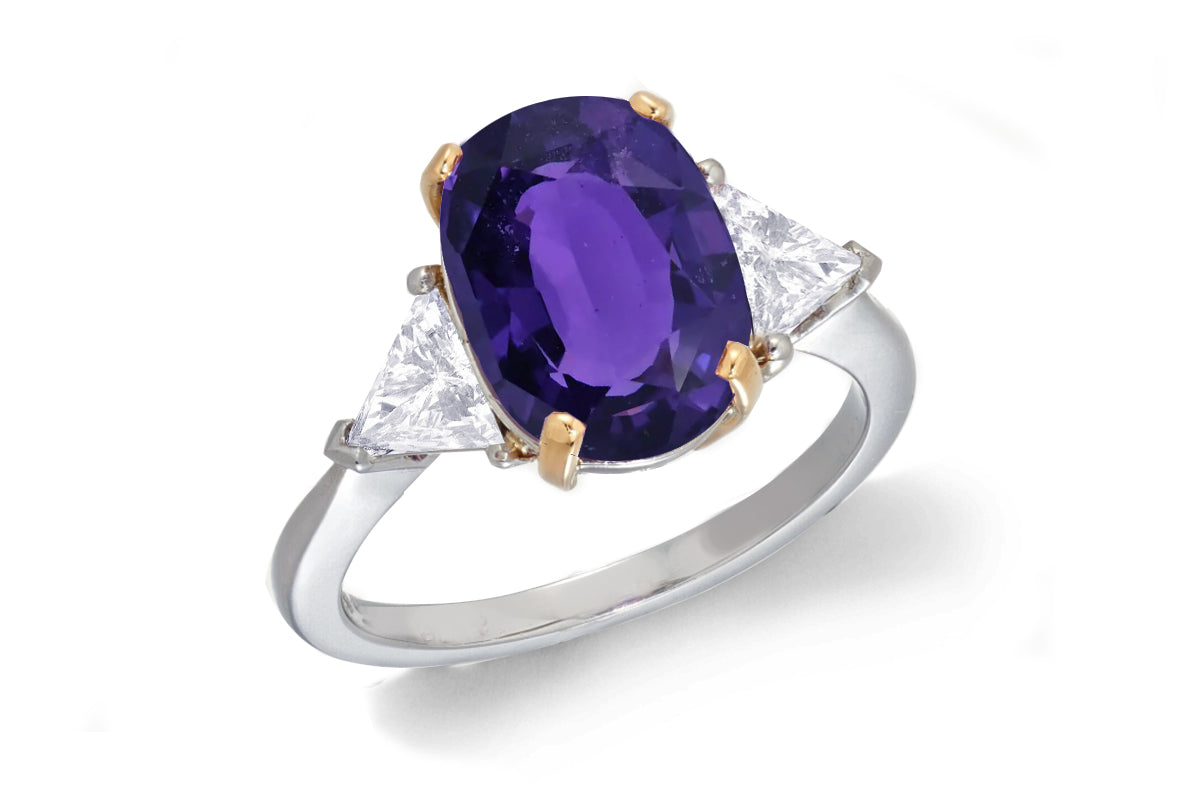 685 custom made unique oval purple sapphire center stone and trillion diamond accent three stone engagement ring