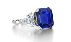 688 custom made unique emerald cut blue sapphire center stone and heart diamond accent three stone engagement ring