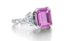 688 custom made unique emerald cut pink sapphire center stone and heart diamond accent three stone engagement ring