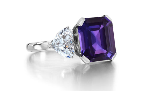 688 custom made unique emerald cut purple sapphire center stone and heart diamond accent three stone engagement ring