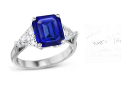 69 custom made unique emerald cut blue sapphire center stone and trillion cut diamond accent three stone engagement ring