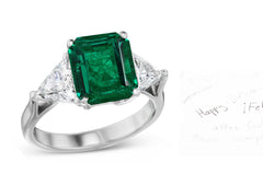 69 custom made unique emerald cut emerald center stone and trillion cut diamond accent three stone engagement ring