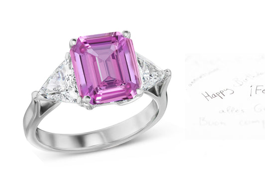 69 custom made unique emerald cut pink sapphire center stone and trillion cut diamond accent three stone engagement ring