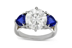 78 custom made unique round diamond and heart blue sapphire side  three stone engagement ring