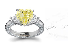 engagement ring three stone with fancy heart yellow diamond center and heart white diamond sides