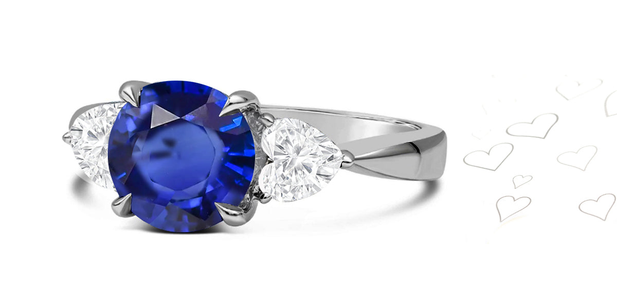 80 custom made unique round blue sapphire and heart diamonde side three stone engagement ring