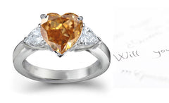 engagement ring three stone with fancy heart brown diamond center and trillion diamond sides