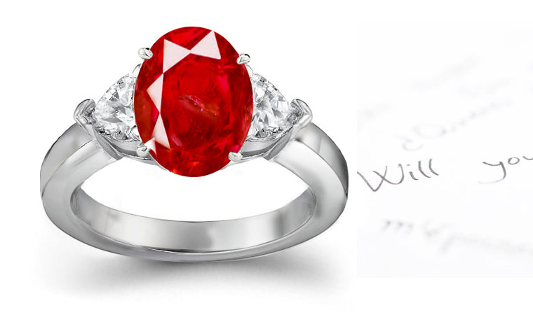 engagement ring three stone with oval ruby center and side heart diamonds