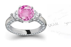 engagement ring with round pink sapphire center and heart/round diamond accents band