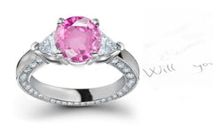 engagement ring with round pink sapphire center and diamond accents band