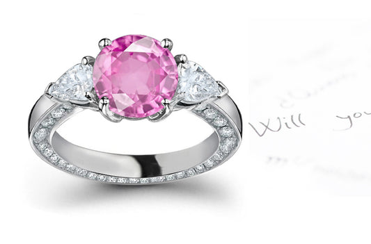 engagement ring with round pink sapphire center and diamond accents band