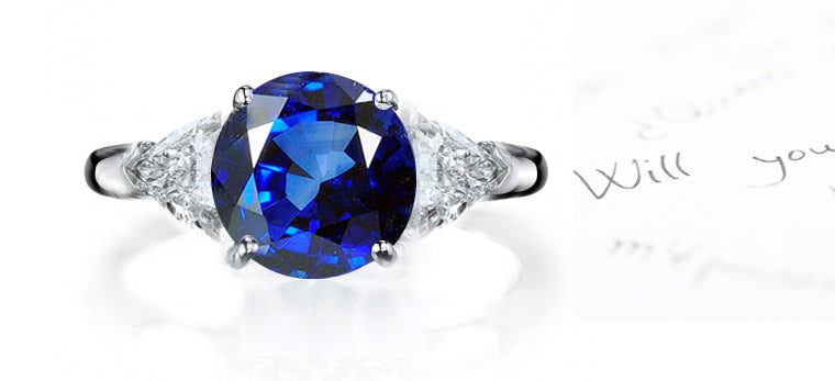 engagement ring three stone with round blue sapphire and side trillion diamonds