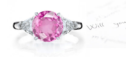 engagement ring three stone with oval pink sapphire center and side trillion diamonds