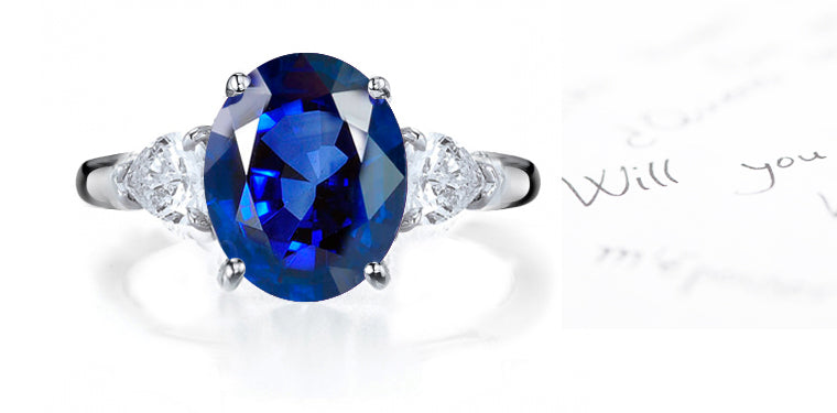 engagement ring three stone with oval blue sapphire and side pear diamonds