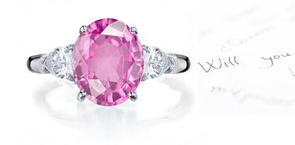 engagement ring three stone with oval pink sapphire center and side pear diamonds