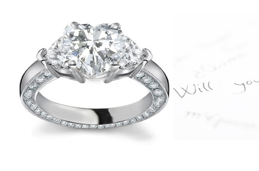 engagement ring handcrafted with heart diamond center and side heart diamonds