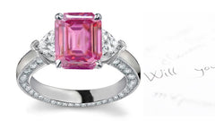 engagement ring handcrafted with emerald cut pink sapphire center and side heart diamonds