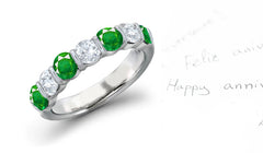 anniversary ring with 7 alternating round emeralds and diamonds