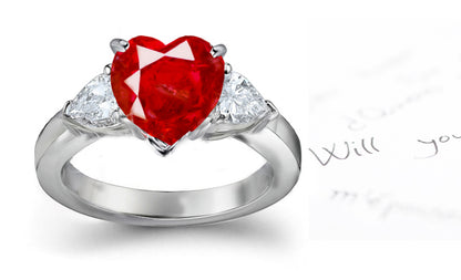 engagement ring three stone with heart ruby center and side pear white diamonds