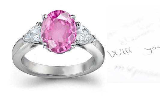 engagement ring three stone with oval pink sapphire center and side pear diamonds